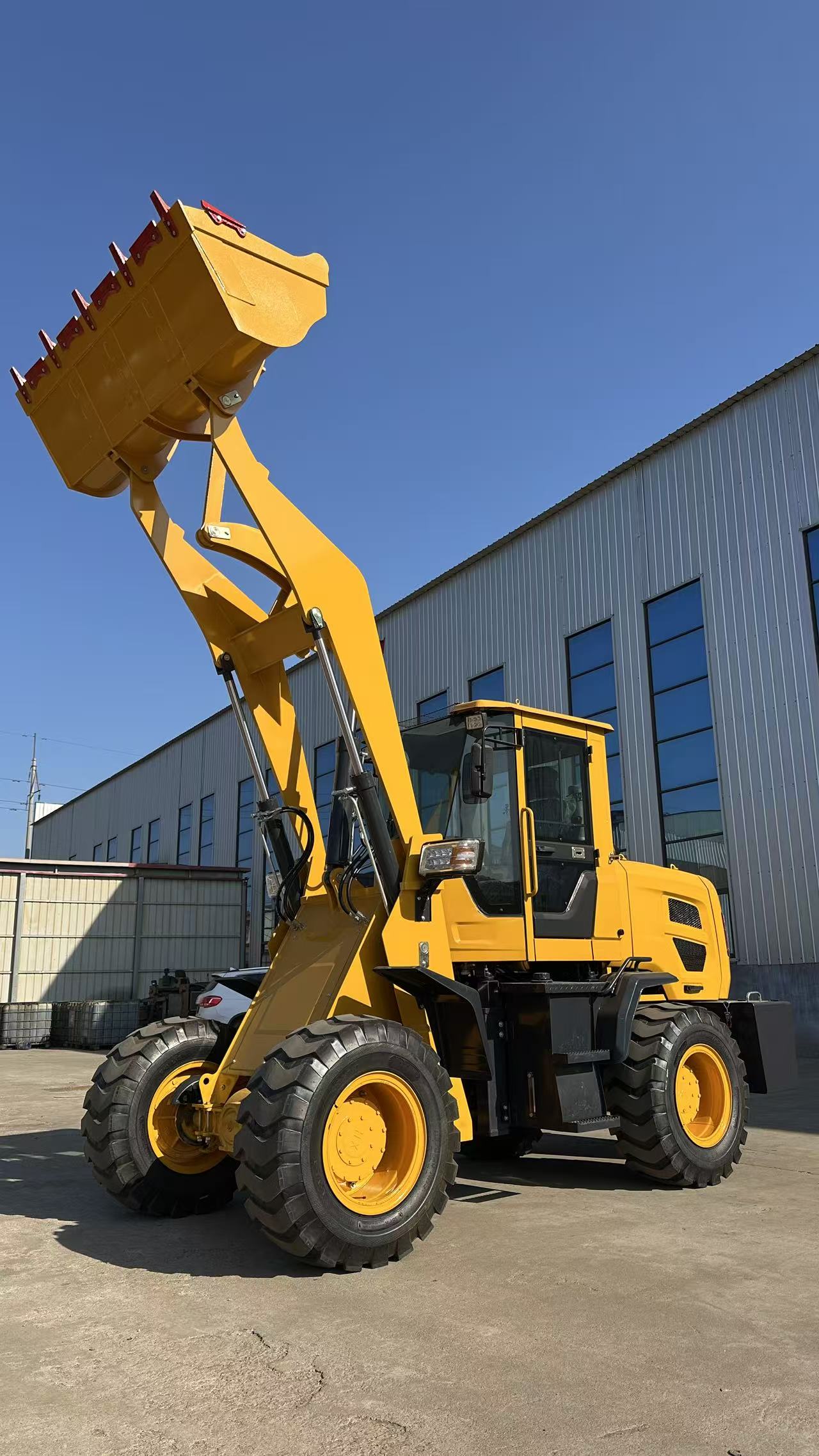 Wheel loader with raised bucket