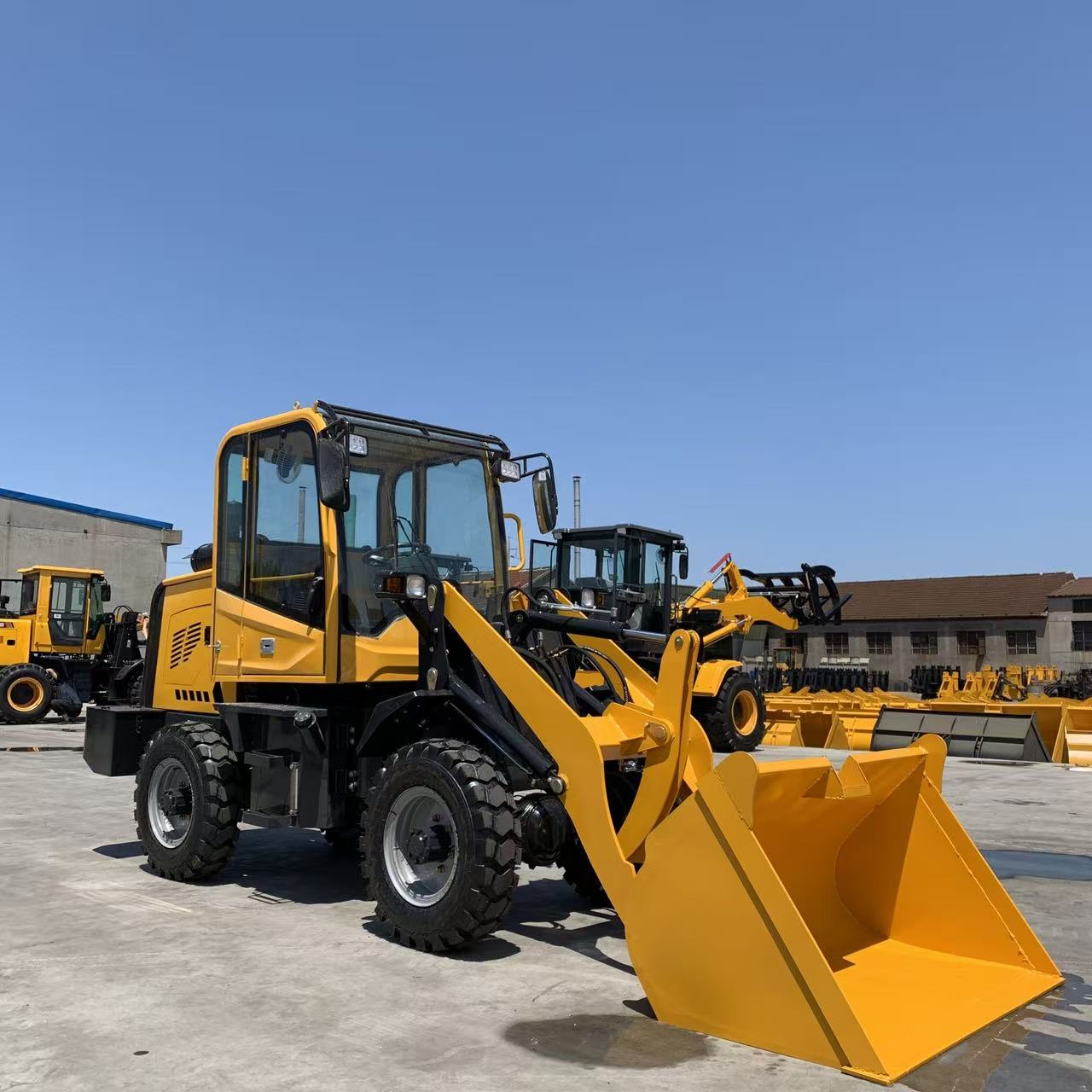Compact yellow wheel loader in yard